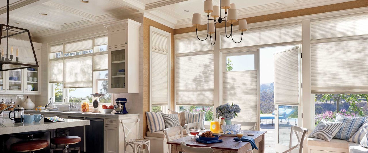Kitchen and dining room with open door and Duette shades.